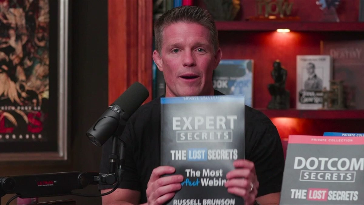 Russell Brunson holding the Expert Secrets Lost Secrets edition